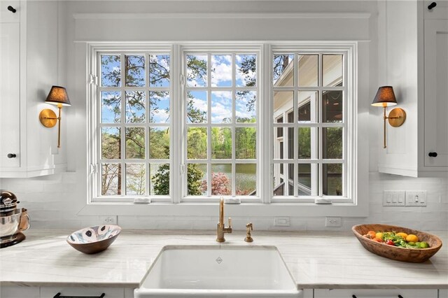 1141 Ragley Hall Rd NE, Brookhaven, GA 30319 - kitchen featuring a sink, tasteful backsplash, white cabinetry, and light stone counters