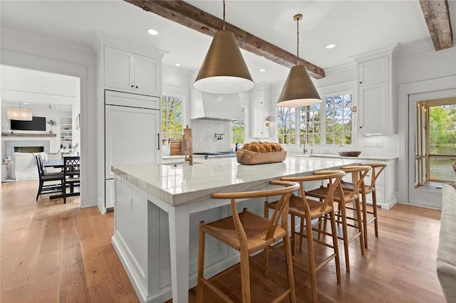 1141 Ragley Hall Rd NE, Brookhaven, GA 30319 - kitchen with white cabinets, wall chimney range hood, double oven range, and decorative backsplash