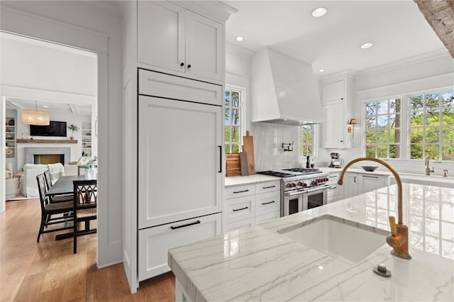 1141 Ragley Hall Rd NE, Brookhaven, GA 30319 - kitchen with a sink, a spacious island, white cabinetry, beamed ceiling, and decorative light fixtures