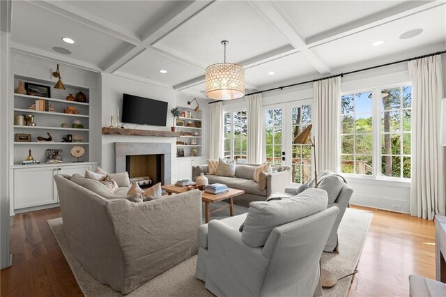 1141 Ragley Hall Rd NE, Brookhaven, GA 30319 - living area featuring coffered ceiling, plenty of natural light, wood finished floors, a fireplace, and beamed ceiling
