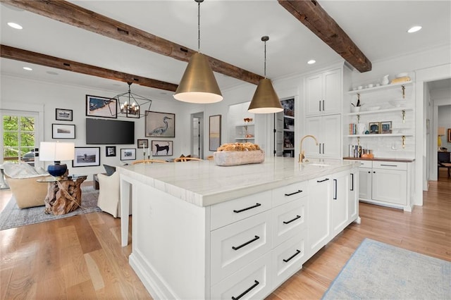 1141 Ragley Hall Rd NE, Brookhaven, GA 30319 - kitchen with beamed ceiling, open shelves, a sink, light wood-type flooring, and open floor plan