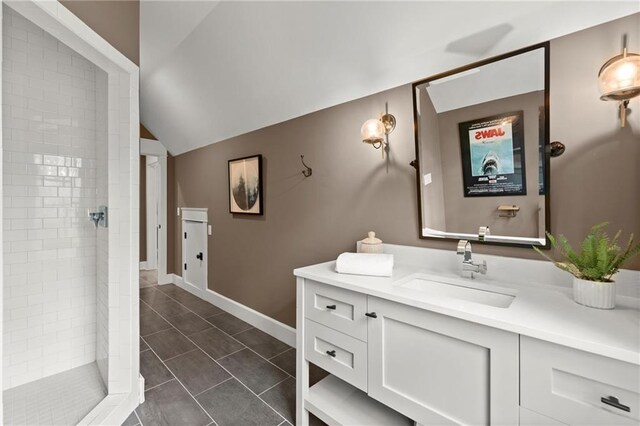 1141 Ragley Hall Rd NE, Brookhaven, GA 30319 - full bath with vanity, a stall shower, vaulted ceiling, tile patterned flooring, and baseboards