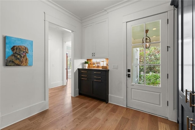 1141 Ragley Hall Rd NE, Brookhaven, GA 30319 - doorway with baseboards, light wood-style floors, and crown molding
