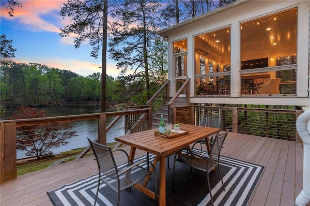 1141 Ragley Hall Rd NE, Brookhaven, GA 30319 - deck at dusk featuring outdoor dining area, a water view, and stairway