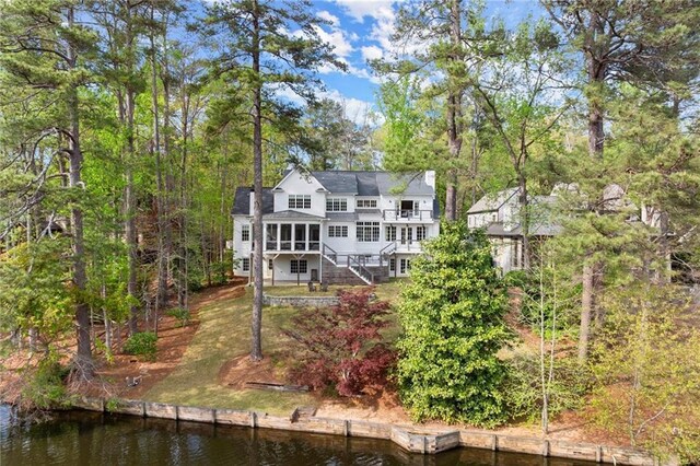 1141 Ragley Hall Rd NE, Brookhaven, GA 30319 - rear view of property featuring a sunroom, stairway, and a deck with water view
