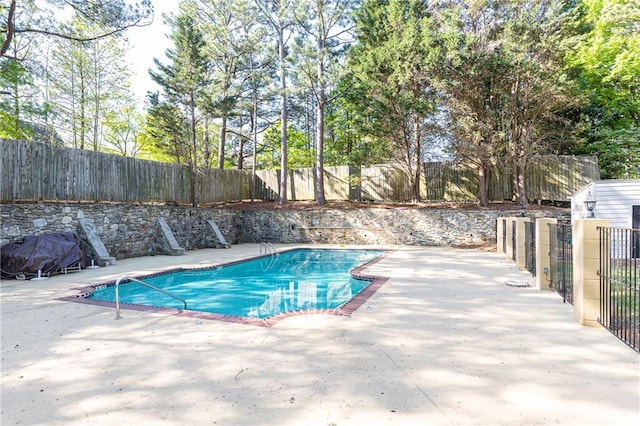 view of pool featuring a fenced backyard, a fenced in pool, and a patio area