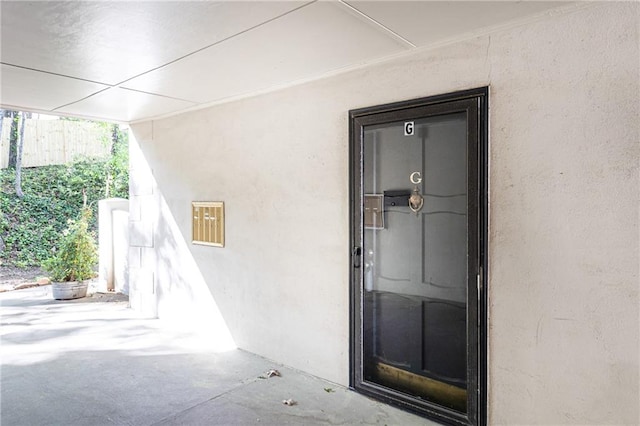 doorway to property featuring stucco siding