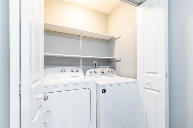 laundry room with separate washer and dryer and laundry area