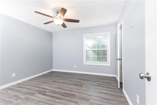 unfurnished room featuring a textured ceiling, wood finished floors, ceiling fan, and baseboards