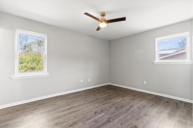 spare room with ceiling fan and dark hardwood / wood-style floors