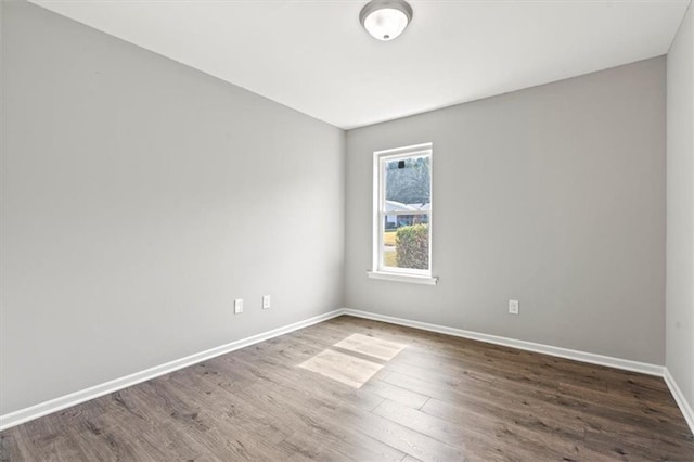 spare room with dark wood-type flooring