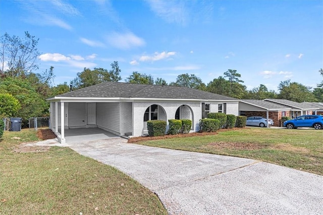 single story home featuring a front lawn and a carport