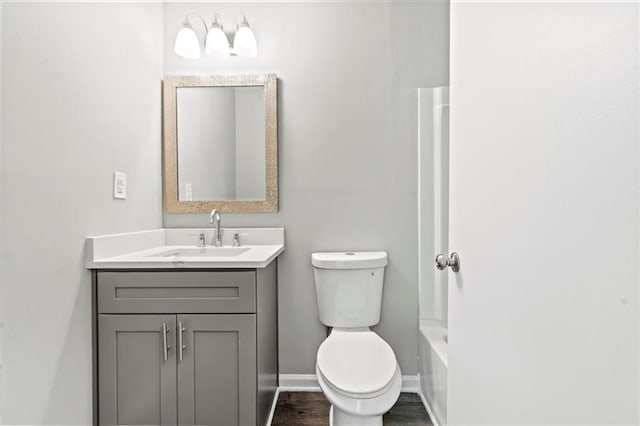 full bathroom with vanity, toilet, hardwood / wood-style flooring, and plus walk in shower