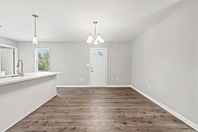 interior space with sink, dark hardwood / wood-style flooring, and a chandelier