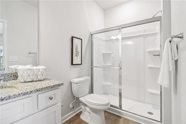 11113 Suria Dr, Covington, GA 30014 - full bathroom featuring wood finished floors, vanity, and a stall shower