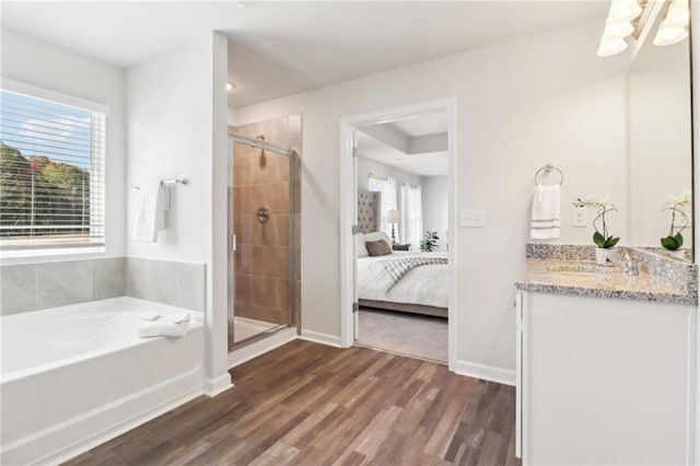 11113 Suria Dr, Covington, GA 30014 - bathroom featuring healthy amount of natural light, vanity, a bath, and a stall shower