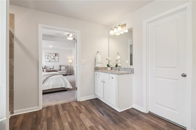11113 Suria Dr, Covington, GA 30014 - bathroom with vanity, wood finished floors, connected bathroom, and ceiling fan