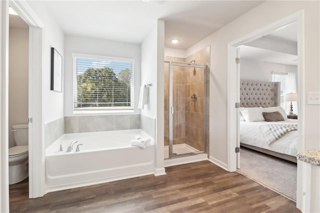 11113 Suria Dr, Covington, GA 30014 - bathroom featuring a bath, connected bathroom, a stall shower, and wood finished floors
