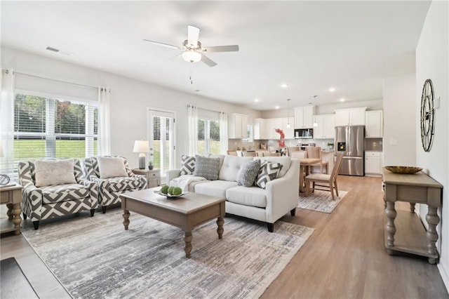 11113 Suria Dr, Covington, GA 30014 - living area featuring plenty of natural light, ceiling fan, light wood-style floors, and recessed lighting