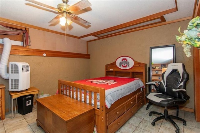 bedroom with a textured wall, ceiling fan, and light tile patterned floors