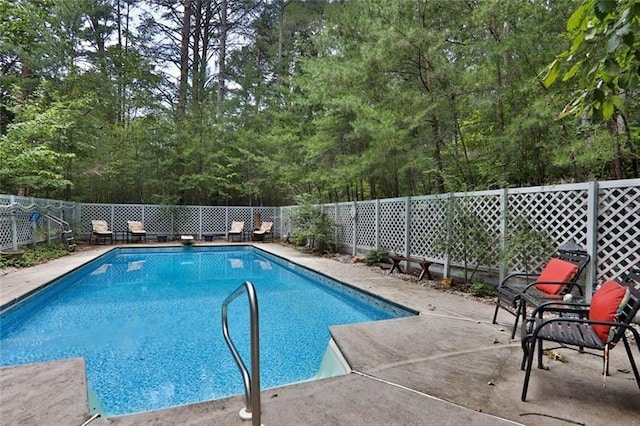 view of pool with a patio, a diving board, a fenced in pool, and a fenced backyard