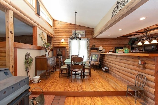dining space with recessed lighting, log walls, wood finished floors, and a chandelier