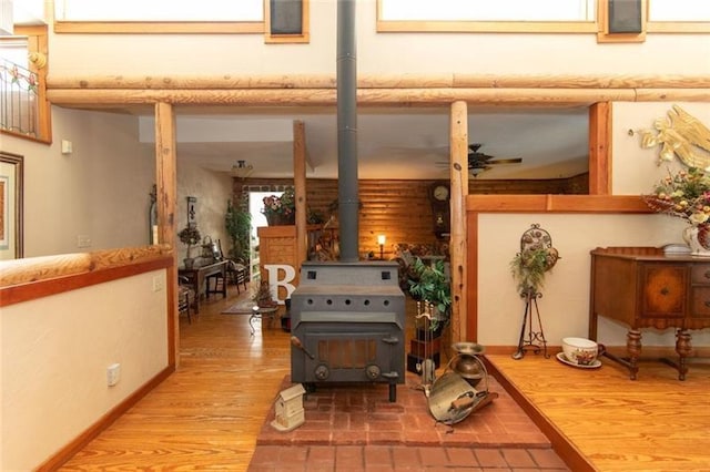 living area featuring a wood stove and wood finished floors