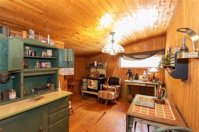 interior space with light wood finished floors, wooden walls, and wooden ceiling