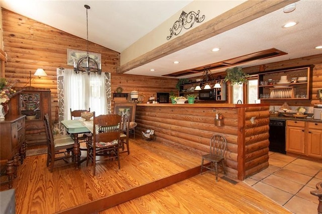 dining room featuring recessed lighting, rustic walls, a chandelier, and vaulted ceiling
