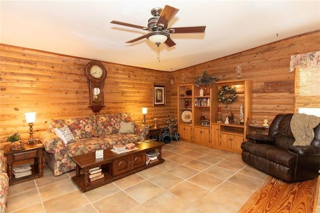 living area with vaulted ceiling, tile patterned flooring, and a ceiling fan