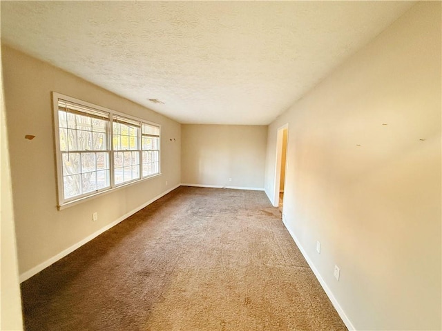 spare room with carpet floors and a textured ceiling