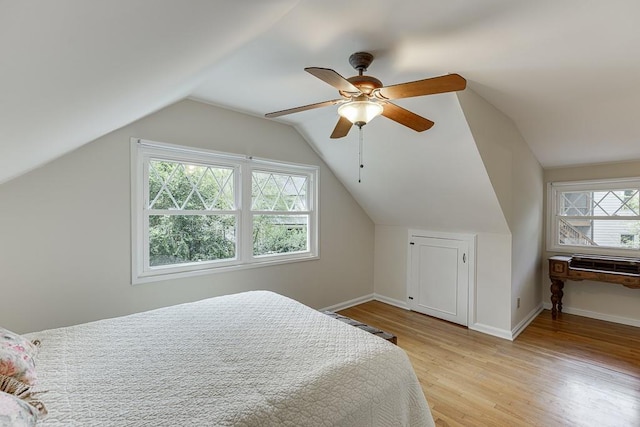 3219 Parkridge Cres, Chamblee, GA 30341 - bedroom with multiple windows, light wood-type flooring, vaulted ceiling, and ceiling fan
