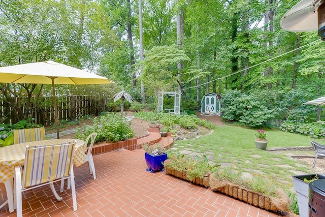 3219 Parkridge Cres, Chamblee, GA 30341 - fenced backyard featuring a shed, a patio area, outdoor dining area, and view of wooded area
