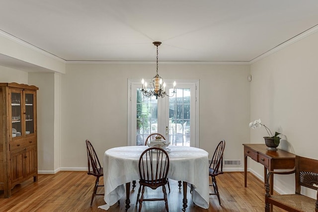 3219 Parkridge Cres, Chamblee, GA 30341 - dining space featuring a chandelier, light wood finished floors, and ornamental molding