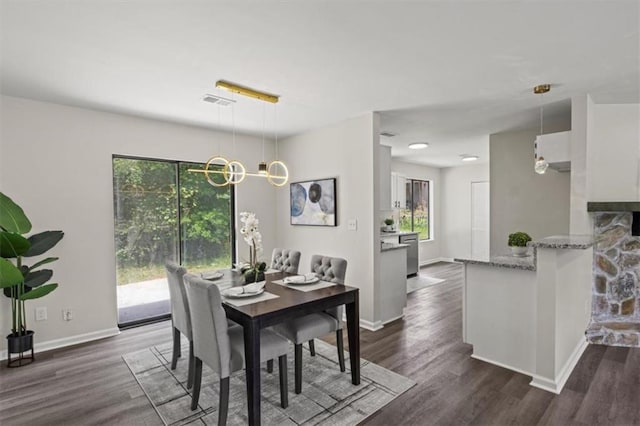 4912 Bayside Ct, Stone Mountain, GA 30088 - dining area featuring plenty of natural light, dark wood finished floors, and a chandelier