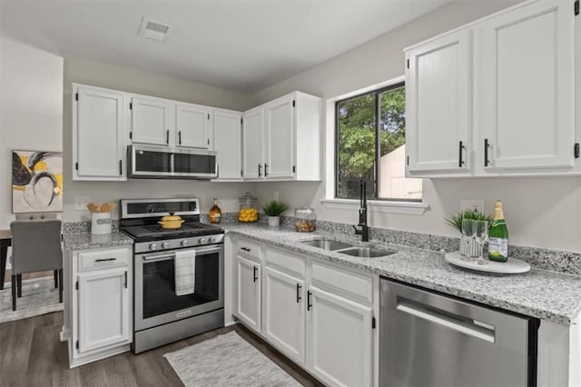 4912 Bayside Ct, Stone Mountain, GA 30088 - kitchen featuring stainless steel appliances, white cabinetry, and light stone countertops