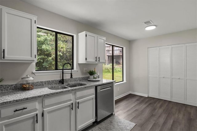 4912 Bayside Ct, Stone Mountain, GA 30088 - kitchen featuring stainless steel dishwasher, white cabinetry, light stone countertops, and dark wood-style floors