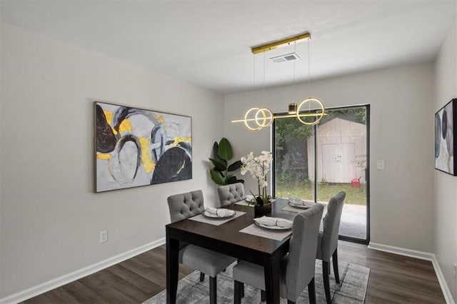 4912 Bayside Ct, Stone Mountain, GA 30088 - dining area featuring dark wood-style floors and a chandelier