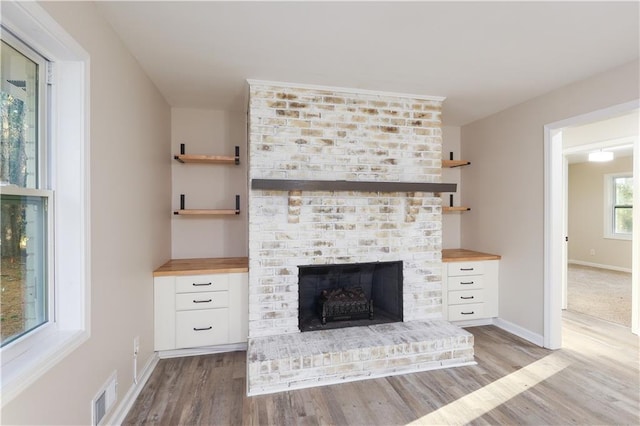 room details with wood-type flooring and a brick fireplace