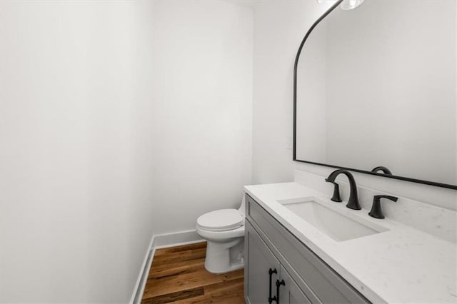 2018 Presley Way NE, Atlanta, GA 30317 - bathroom featuring vanity, wood finished floors, toilet, and baseboards