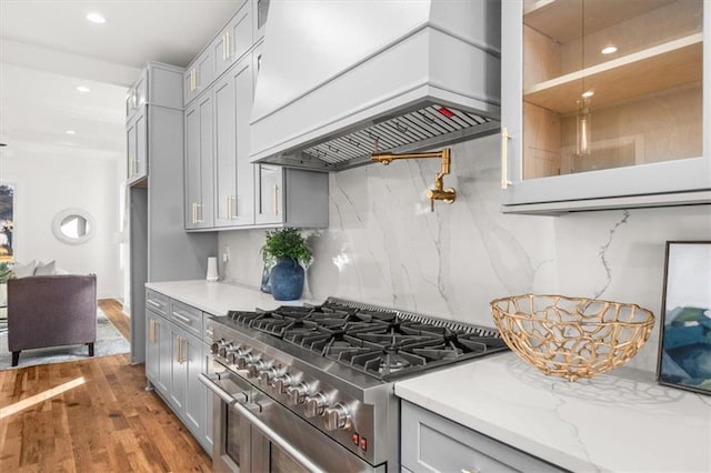 2018 Presley Way NE, Atlanta, GA 30317 - kitchen with high end stainless steel range oven, custom range hood, gray cabinets, decorative backsplash, and wood finished floors