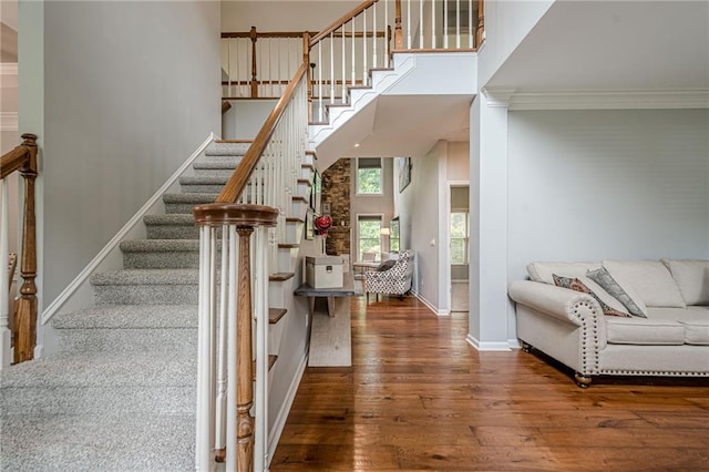 10865 Glenhurst Pass, Duluth, GA 30097 - stairway featuring wood finished floors, ornamental molding, and a towering ceiling