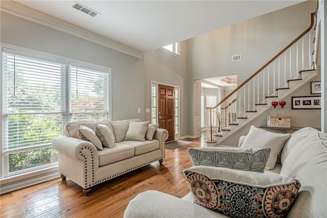 10865 Glenhurst Pass, Duluth, GA 30097 - living room with stairway, healthy amount of natural light, light wood-style floors, and ornamental molding