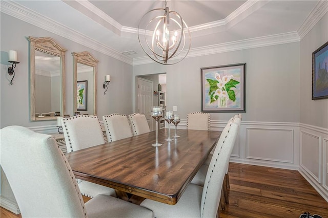 10865 Glenhurst Pass, Duluth, GA 30097 - dining area featuring a tray ceiling, a chandelier, dark wood-type flooring, crown molding, and wainscoting