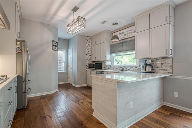 10865 Glenhurst Pass, Duluth, GA 30097 - kitchen featuring stainless steel appliances, tasteful backsplash, dark wood-style floors, and light countertops