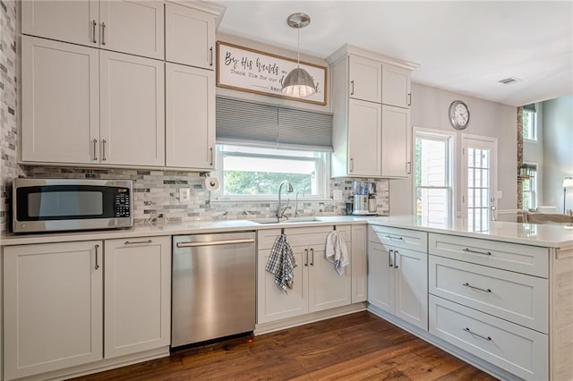 10865 Glenhurst Pass, Duluth, GA 30097 - kitchen featuring appliances with stainless steel finishes, a peninsula, light countertops, backsplash, and dark wood-style flooring