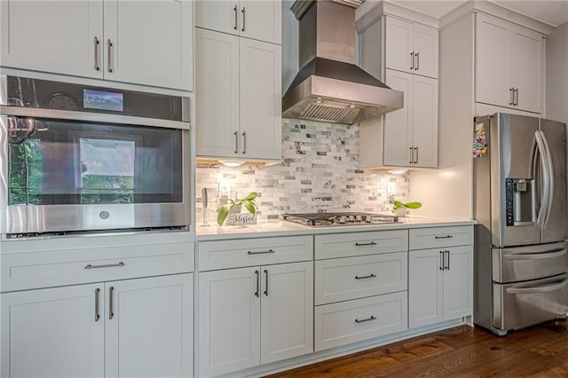10865 Glenhurst Pass, Duluth, GA 30097 - kitchen with appliances with stainless steel finishes, wall chimney range hood, dark wood-style floors, and light countertops