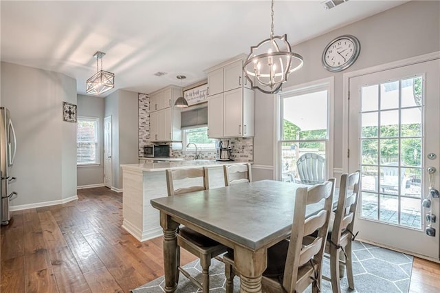10865 Glenhurst Pass, Duluth, GA 30097 - dining space featuring a chandelier, wood-type flooring, and plenty of natural light