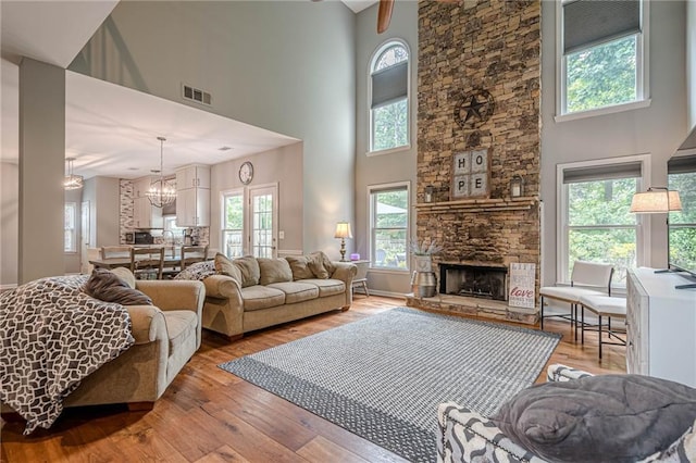 10865 Glenhurst Pass, Duluth, GA 30097 - living area featuring a high ceiling, healthy amount of natural light, light wood-style flooring, and a chandelier