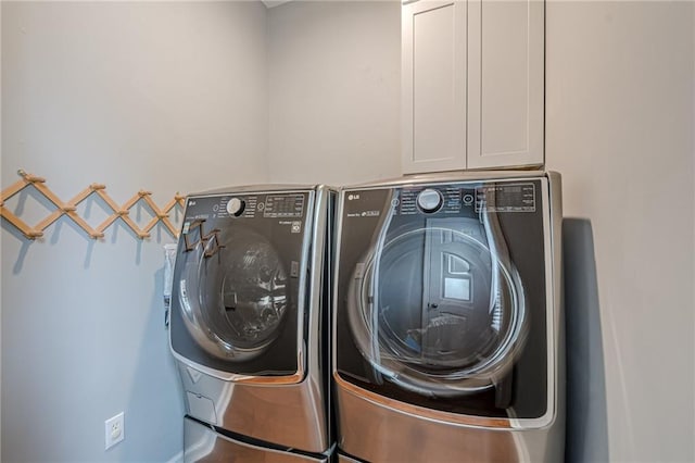 10865 Glenhurst Pass, Duluth, GA 30097 - laundry room featuring washing machine and clothes dryer and cabinet space